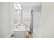 Well-lit bathroom with a white sink, toilet, and a shower-tub combination with a blue shower curtain at 818 Eastern Ave, Rocky Mount, NC 27801
