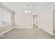 Elegant dining room with neutral walls, gray carpeting, decorative chandelier, and large window at 818 Eastern Ave, Rocky Mount, NC 27801