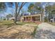 Lovely brick home with a spacious covered porch, surrounded by mature trees and a lush lawn at 818 Eastern Ave, Rocky Mount, NC 27801