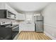 Cozy kitchen with white cabinets, updated stainless appliances and new plank flooring at 818 Eastern Ave, Rocky Mount, NC 27801