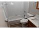 Bathroom with white tile tub surround, toilet, and vanity with modern sink at 107 Ware Ct, Garner, NC 27529