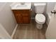 Cozy bathroom with oak vanity, and toilet next to the white countertop sink at 107 Ware Ct, Garner, NC 27529