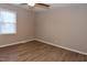 Neutral bedroom with ceiling fan, window, and light-colored flooring at 107 Ware Ct, Garner, NC 27529