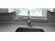 Close-up of the stainless steel kitchen sink and faucet with a window view at 107 Ware Ct, Garner, NC 27529