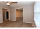 An open living room with multiple doorways and a ceiling fan at 107 Ware Ct, Garner, NC 27529