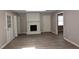 Spacious living room with a painted brick fireplace and neutral paint at 107 Ware Ct, Garner, NC 27529