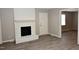 A living room featuring a fireplace, neutral walls and light-colored flooring at 107 Ware Ct, Garner, NC 27529