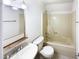 Cozy bathroom with a bathtub and shower, a mirror, and a toilet at 1100 Walter Clark Dr, Hillsborough, NC 27278