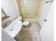 Bathroom featuring pedestal sink and classic tiled shower at 1100 Walter Clark Dr, Hillsborough, NC 27278