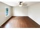 Bright bedroom featuring hardwood floors, a large window, and neutral paint at 1100 Walter Clark Dr, Hillsborough, NC 27278