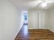 Spacious bedroom with large closet, ceiling fan, and hardwood flooring at 1100 Walter Clark Dr, Hillsborough, NC 27278