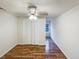 Bedroom with closet, modern ceiling fan, and hardwood floors at 1100 Walter Clark Dr, Hillsborough, NC 27278