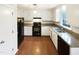 Well-maintained kitchen with granite countertops, modern appliances, and ample cabinet space at 1100 Walter Clark Dr, Hillsborough, NC 27278