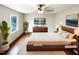Staged main bedroom with modern decor, wood floors, and large window for plenty of natural light at 1100 Walter Clark Dr, Hillsborough, NC 27278