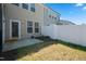 Wide angle of a backyard with a white fence and small concrete slab behind the townhome at 116 Polaris Ave, Garner, NC 27529