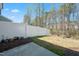 Wide angle of a backyard with a white fence and small concrete slab at 116 Polaris Ave, Garner, NC 27529