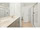 Bathroom featuring double sink vanity, framed mirrors, and glass-enclosed shower at 116 Polaris Ave, Garner, NC 27529