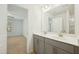 Bathroom featuring a double sink vanity, framed mirror, and an attached room for added convenience at 116 Polaris Ave, Garner, NC 27529