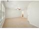 Spacious bedroom with carpeted floors, ceiling fan, and large windows for natural light at 116 Polaris Ave, Garner, NC 27529