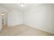 Bright bedroom with white trim and neutral carpet, illuminated by natural light and a ceiling fixture at 116 Polaris Ave, Garner, NC 27529