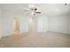 Large primary bedroom with neutral carpet, ceiling fan, and multiple doors for easy access at 116 Polaris Ave, Garner, NC 27529