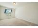 Comfortable bedroom featuring neutral carpet, a large window, and neutral walls at 116 Polaris Ave, Garner, NC 27529