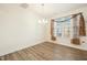 Bright dining room with wood floors, chandelier, and large window with neutral curtains at 116 Polaris Ave, Garner, NC 27529