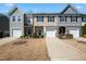 Charming townhome featuring a well-manicured lawn, attached garages, and diverse architectural accents at 116 Polaris Ave, Garner, NC 27529