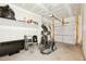 Spacious garage with overhead door and some workout equipment at 116 Polaris Ave, Garner, NC 27529