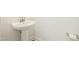 Elegant half bathroom featuring a pedestal sink, white walls, and modern fixtures at 116 Polaris Ave, Garner, NC 27529