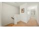 Bright hallway featuring neutral carpet, white trim, and a view to a naturally lit bedroom at 116 Polaris Ave, Garner, NC 27529