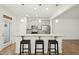 Contemporary kitchen featuring an island with barstool seating, pendant lights, and stainless steel appliances at 116 Polaris Ave, Garner, NC 27529