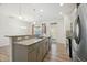 Bright kitchen with a breakfast bar, granite countertops, stainless steel appliances, and view of the dining area at 116 Polaris Ave, Garner, NC 27529