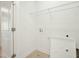 Bright laundry room features white walls, tile flooring, a utility sink, and convenient washer/dryer hookups at 116 Polaris Ave, Garner, NC 27529