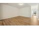 Bright open-concept living room with wood floors that flows into the entryway, offering a welcoming atmosphere at 116 Polaris Ave, Garner, NC 27529