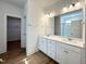 Bright bathroom with double vanity sinks, large mirror, and modern lighting fixtures at 136 Tee Time Ter, Benson, NC 27504