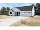 Beautiful one story white home with a two car garage and concrete driveway at 136 Tee Time Ter, Benson, NC 27504