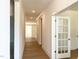 Bright hallway featuring hardwood floors, white trim, and an open floor plan at 136 Tee Time Ter, Benson, NC 27504