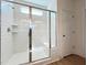 Contemporary tiled shower featuring glass door, with window bringing in natural light at 136 Tee Time Ter, Benson, NC 27504