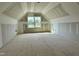 Unfinished attic space with a large window offering natural light at 141 Noramac Ct, Selma, NC 27576