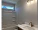 Bathroom features a tub and shower combination, and a modern vanity at 141 Noramac Ct, Selma, NC 27576