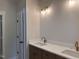 Bathroom featuring double sinks, stylish vanity, and modern lighting fixtures at 141 Noramac Ct, Selma, NC 27576