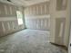 Spacious bedroom with fresh drywall, featuring a window with natural light at 141 Noramac Ct, Selma, NC 27576