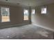 Bedroom with three windows offering a sun-filled space and backyard views at 141 Noramac Ct, Selma, NC 27576