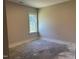 Bedroom with a view of the yard through a large window, and neutral paint at 141 Noramac Ct, Selma, NC 27576