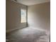 Bedroom with large window offering backyard views and natural light at 141 Noramac Ct, Selma, NC 27576