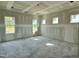 Unfinished bedroom with many windows providing natural light, creating a bright and welcoming atmosphere at 141 Noramac Ct, Selma, NC 27576