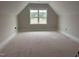Upstairs bonus room offering a sun-filled space with backyard views at 141 Noramac Ct, Selma, NC 27576