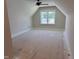 Spacious bonus room with large window and modern ceiling fan at 141 Noramac Ct, Selma, NC 27576