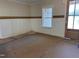 Entryway with white wainscoting, a wood accent wall, and hardwood door with glass at 141 Noramac Ct, Selma, NC 27576